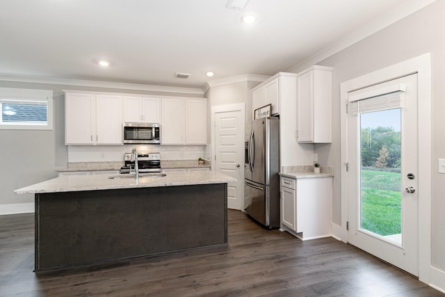 kitchen with dark wood-type flooring, sink, white cabinetry, appliances with stainless steel finishes, and an island with sink