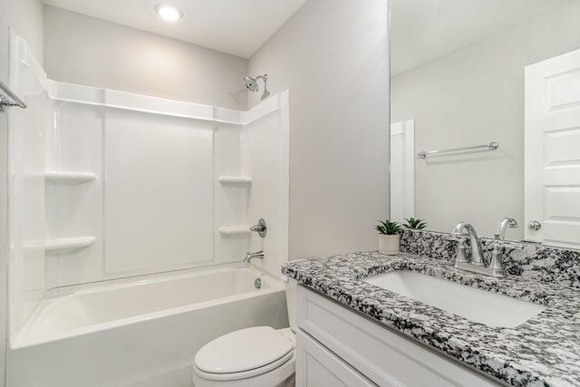 full bathroom featuring vanity, washtub / shower combination, and toilet