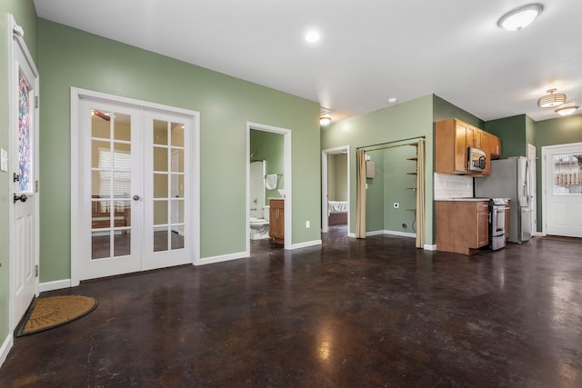 unfurnished living room featuring french doors