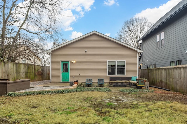 rear view of property with a lawn