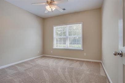 unfurnished room with light colored carpet and ceiling fan