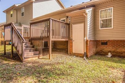 back of property with a wooden deck