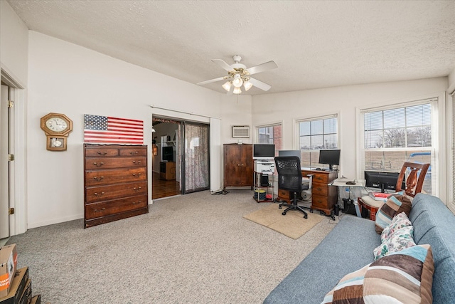 carpeted office space featuring ceiling fan and a textured ceiling