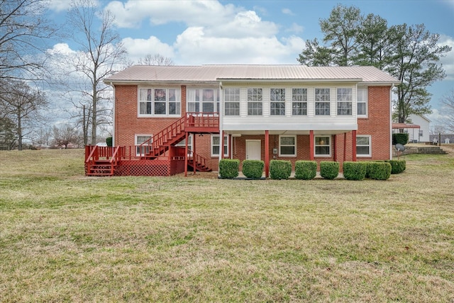 view of front of property with a front yard and a deck