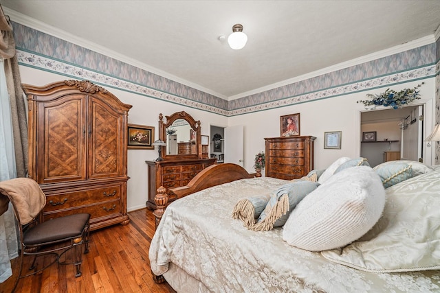 bedroom with crown molding and hardwood / wood-style floors