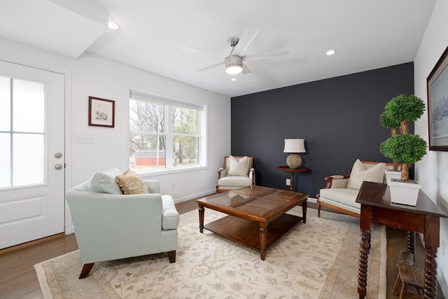 living room with light hardwood / wood-style floors and ceiling fan