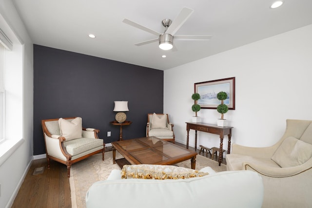 living area featuring hardwood / wood-style flooring and ceiling fan