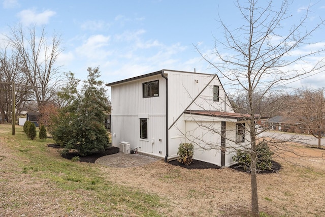 back of property featuring a yard and central AC unit