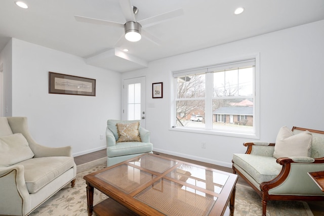 living room featuring wood-type flooring and ceiling fan