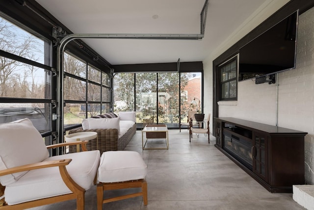 sunroom / solarium with a fireplace