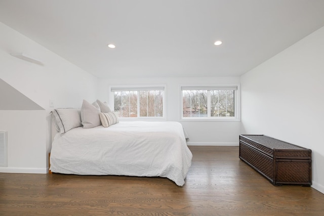 bedroom featuring dark hardwood / wood-style floors and multiple windows