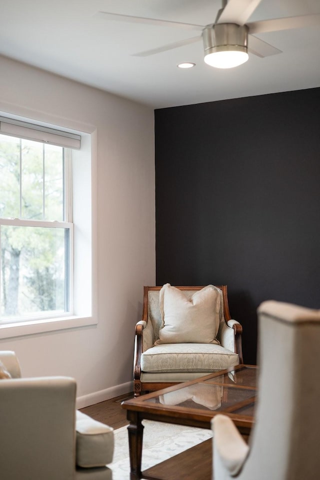 sitting room featuring hardwood / wood-style floors and ceiling fan