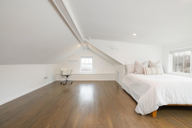 unfurnished bedroom with dark hardwood / wood-style flooring and lofted ceiling with beams