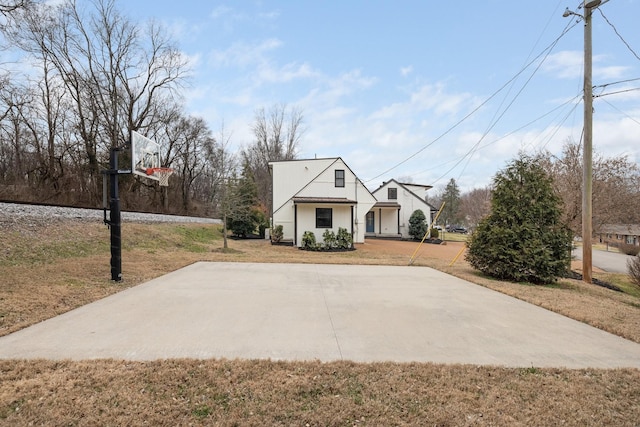 view of front of house featuring basketball court and a front yard