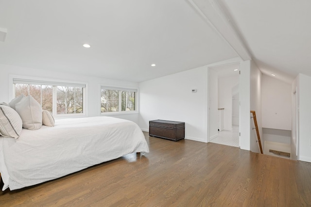 bedroom featuring lofted ceiling and hardwood / wood-style flooring