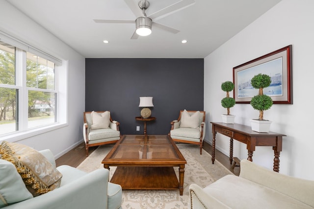 sitting room featuring ceiling fan and light wood-type flooring