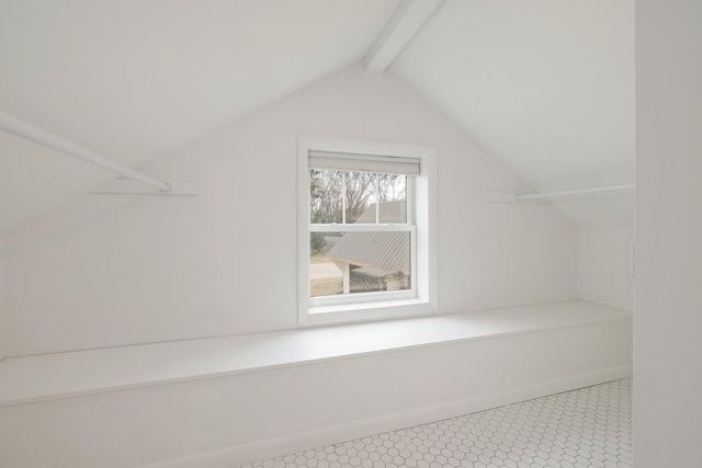 walk in closet featuring lofted ceiling with beams