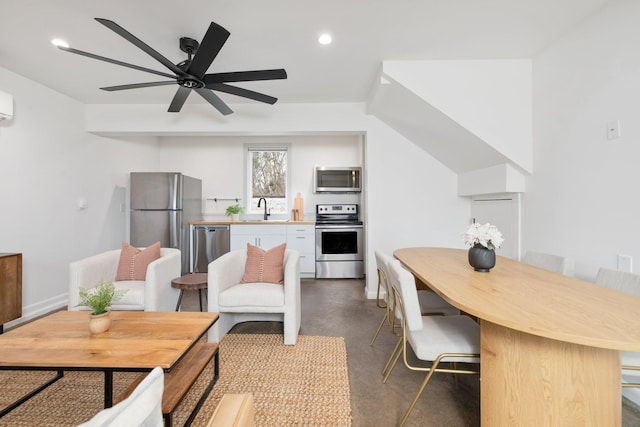 interior space featuring sink, a wall mounted air conditioner, and ceiling fan