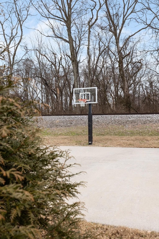 view of patio / terrace with a water view and basketball court