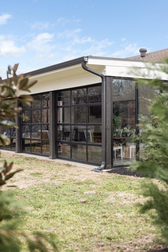 back of house featuring a sunroom