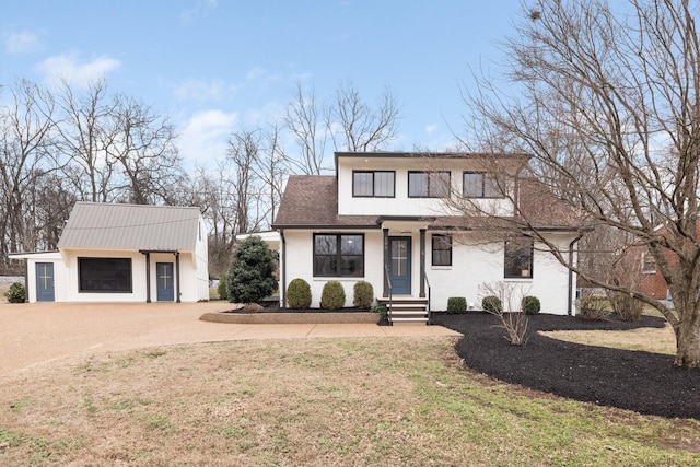 view of front of home with a garage and a front lawn