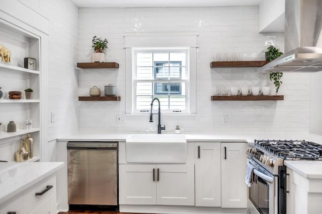 kitchen with island range hood, white cabinetry, sink, decorative backsplash, and stainless steel appliances