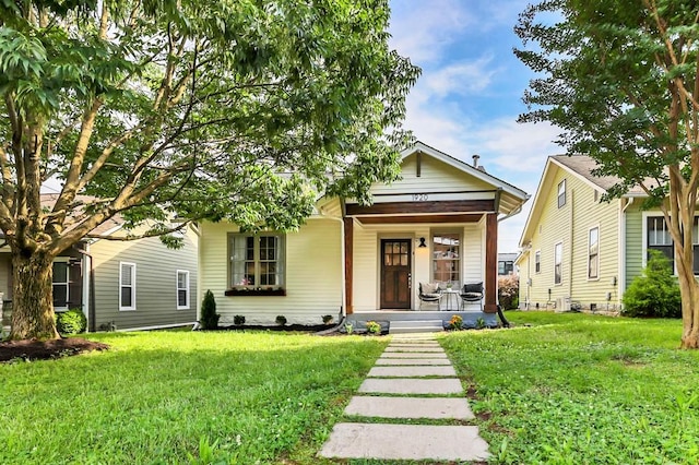 view of front facade with a front yard and covered porch