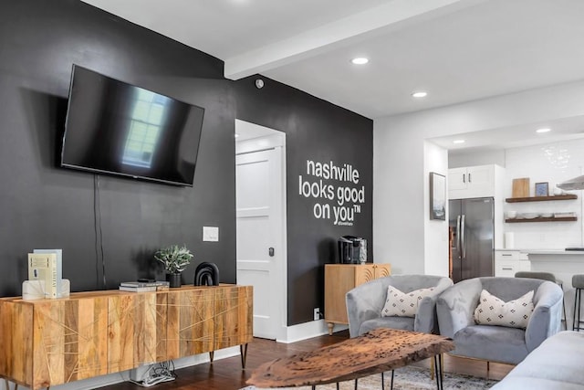 living room with beam ceiling and dark hardwood / wood-style flooring