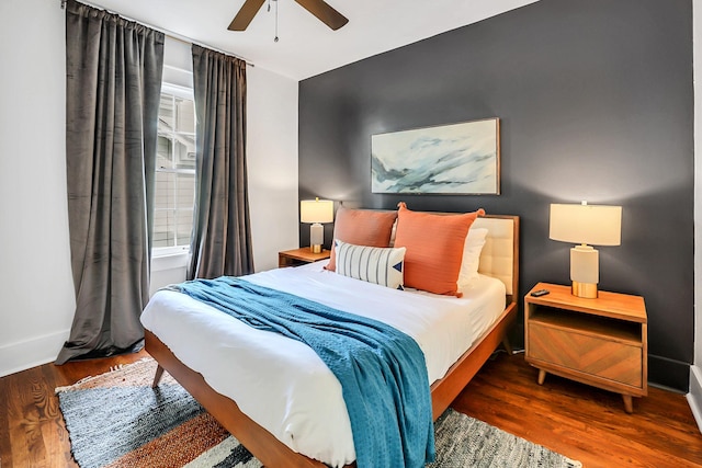 bedroom with dark wood-type flooring and ceiling fan