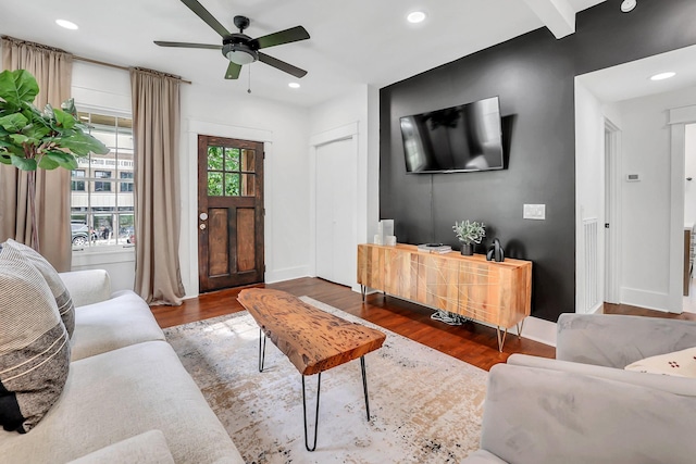 living room featuring dark hardwood / wood-style floors and ceiling fan