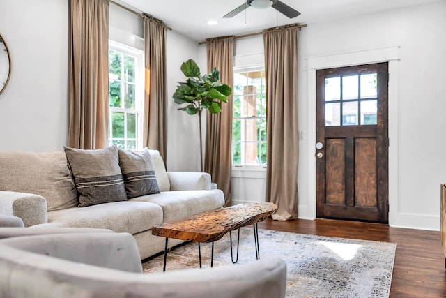 living room featuring dark hardwood / wood-style flooring and ceiling fan