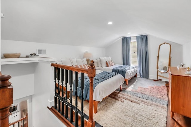 bedroom with vaulted ceiling and carpet flooring