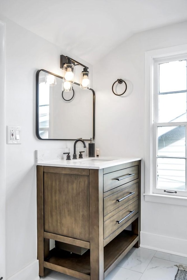 bathroom featuring lofted ceiling, vanity, and a wealth of natural light