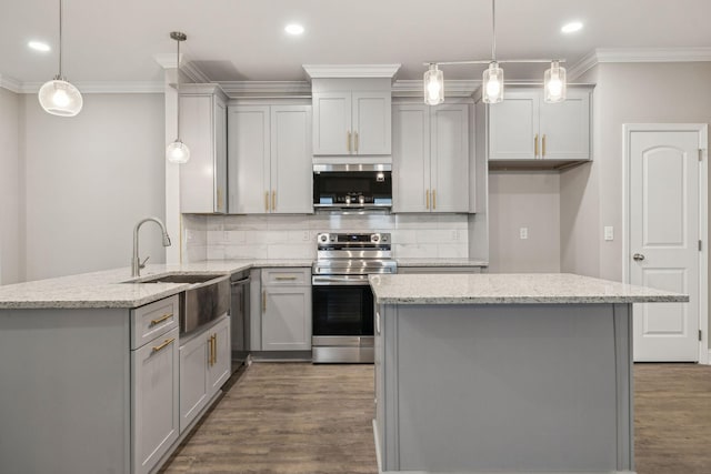 kitchen featuring dark hardwood / wood-style floors, pendant lighting, sink, light stone counters, and stainless steel appliances