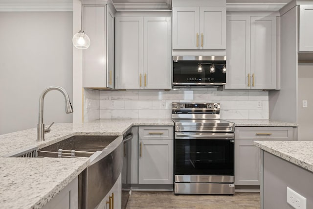 kitchen with pendant lighting, appliances with stainless steel finishes, and gray cabinetry