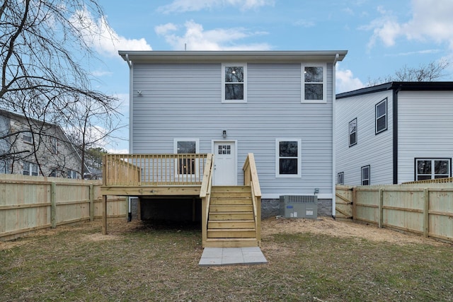 back of house with a wooden deck, a yard, and central air condition unit