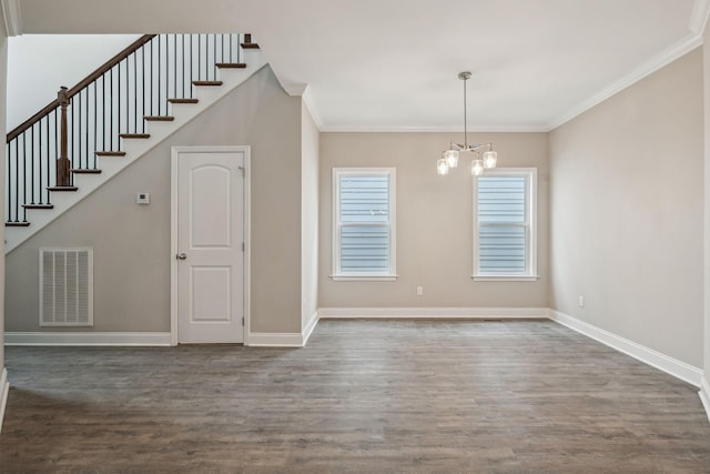 interior space featuring dark hardwood / wood-style flooring, ornamental molding, and a chandelier