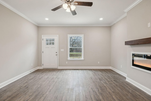 unfurnished living room featuring dark hardwood / wood-style flooring, ornamental molding, and ceiling fan