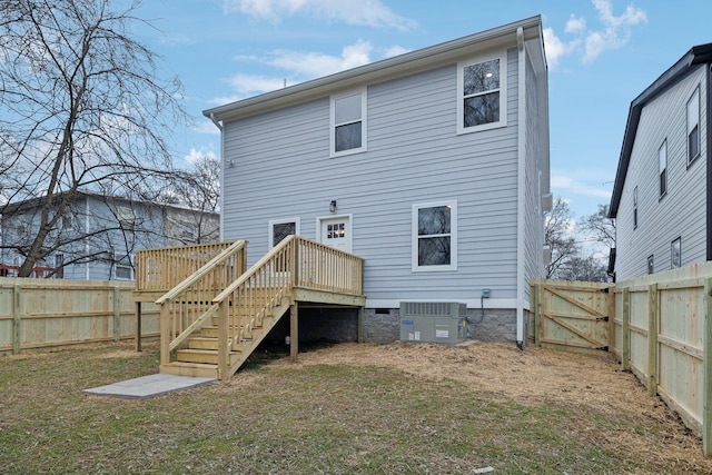 back of property with cooling unit, a yard, and a deck