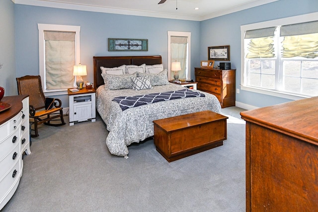 carpeted bedroom featuring ornamental molding and ceiling fan