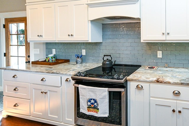 kitchen featuring stainless steel range with electric cooktop and white cabinets