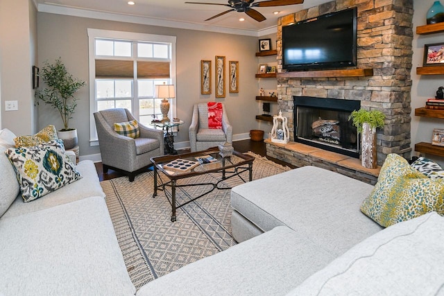 living room featuring hardwood / wood-style flooring, crown molding, a stone fireplace, and ceiling fan