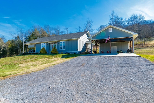 ranch-style home featuring a carport and a front yard