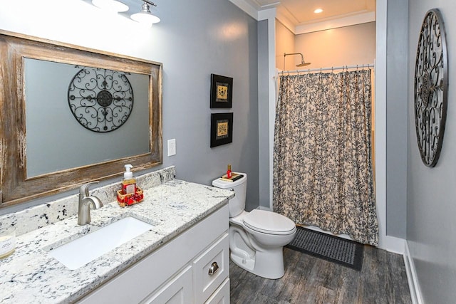 bathroom featuring walk in shower, toilet, crown molding, vanity, and hardwood / wood-style floors