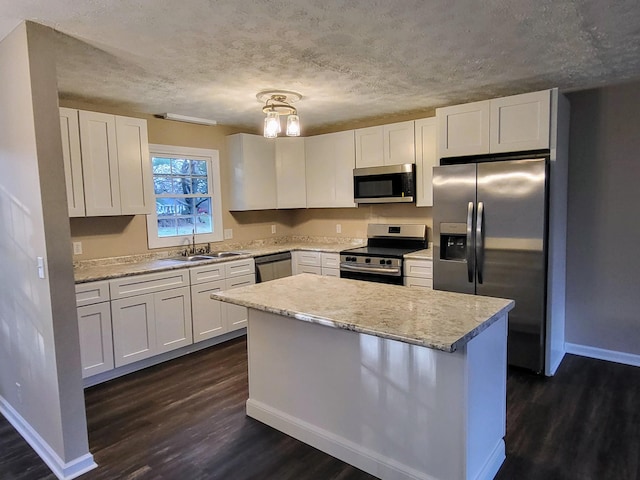 kitchen featuring appliances with stainless steel finishes, sink, and white cabinets