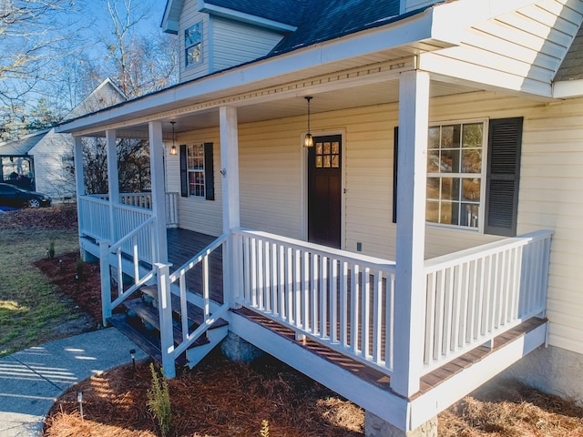 view of exterior entry featuring covered porch