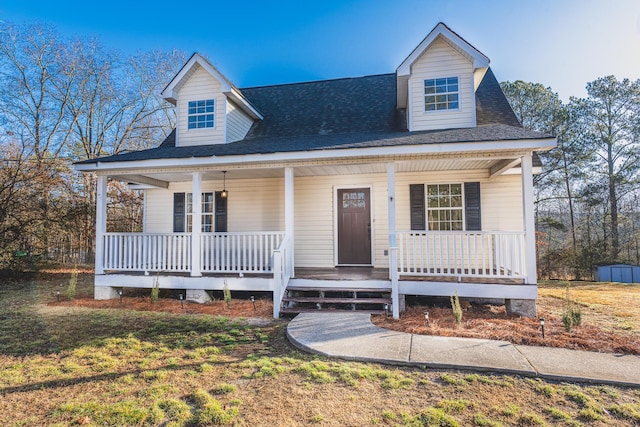 view of front of house featuring covered porch and a front lawn