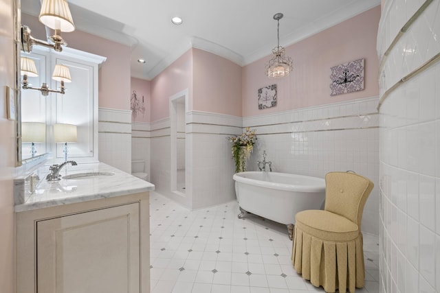 bathroom featuring vanity, ornamental molding, tile walls, and a tub to relax in