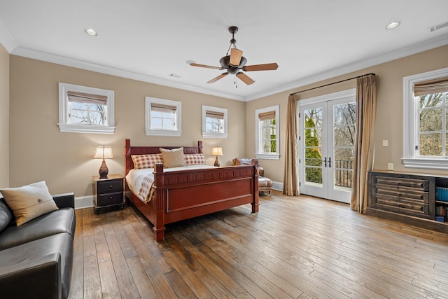 bedroom featuring french doors, multiple windows, and access to outside