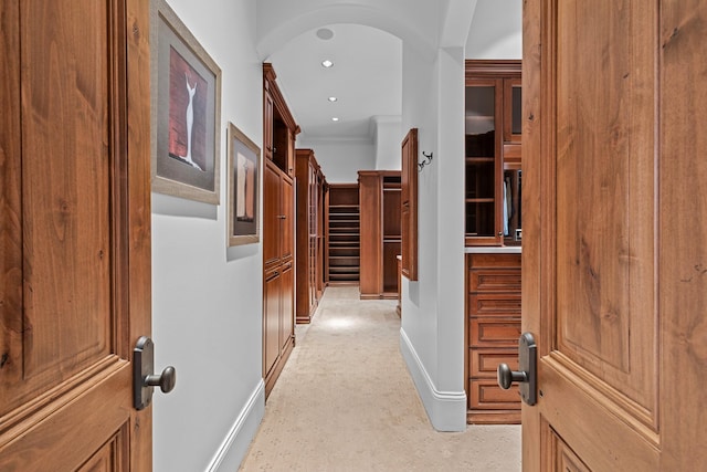 hallway featuring ornamental molding